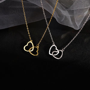 Interlocking heart pendant necklaces in gold and silver, delicate jewelry for women.