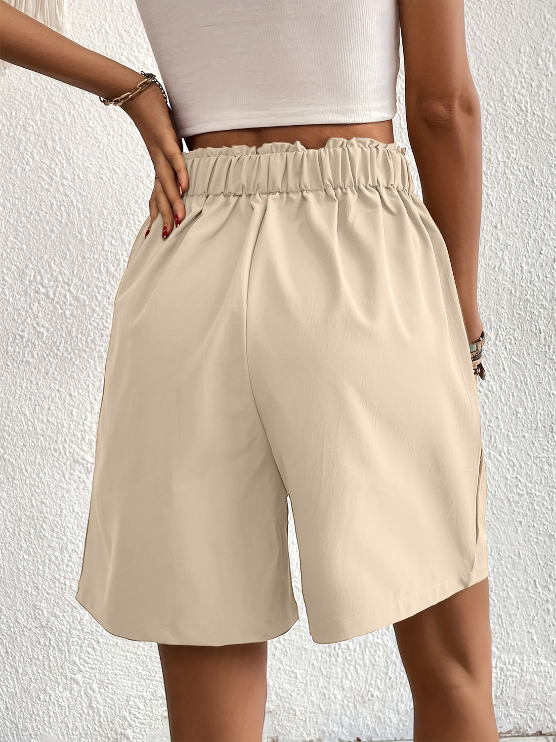 Beige pleated front bermuda shorts with elastic waistband and side pockets