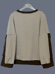 Brown and white striped sweatshirt with decorative buttons on the sides.