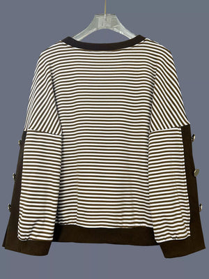 Brown and white striped sweatshirt with decorative buttons on the sides.
