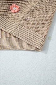 Khaki knit sweater with embroidered floral detail and ribbed trim.