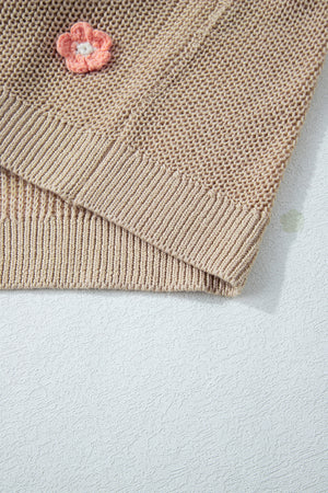 Khaki knit sweater with embroidered floral detail and ribbed trim.