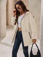 Cream hooded windbreaker jacket with ruffled waistline and black trim