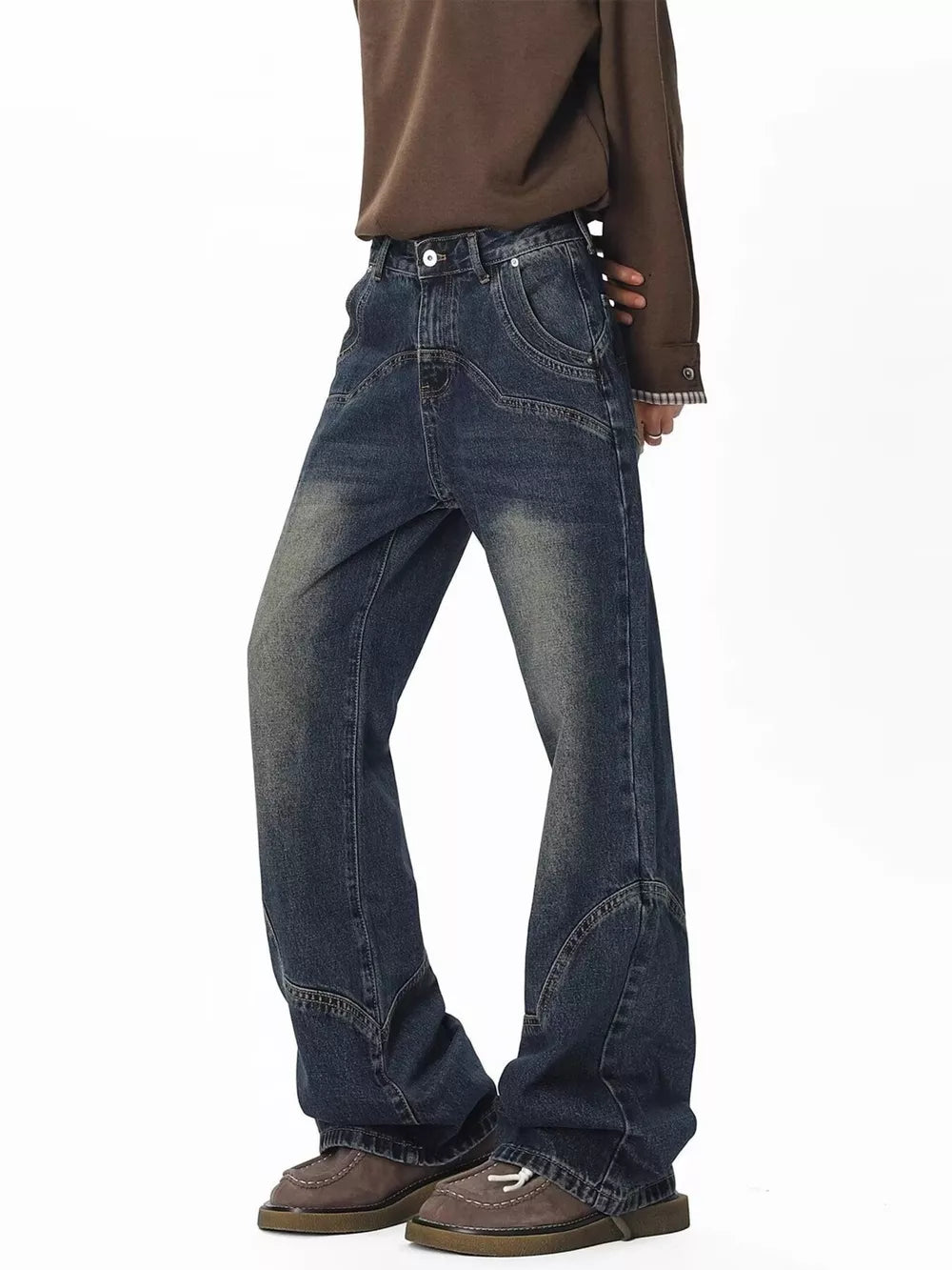 Men's vintage wash wide leg jeans in dark blue denim with distressed details.