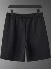 Black knit shorts with diamond pattern and elastic waistband