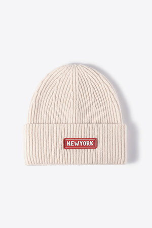 Beige ribbed acrylic beanie with New York patch