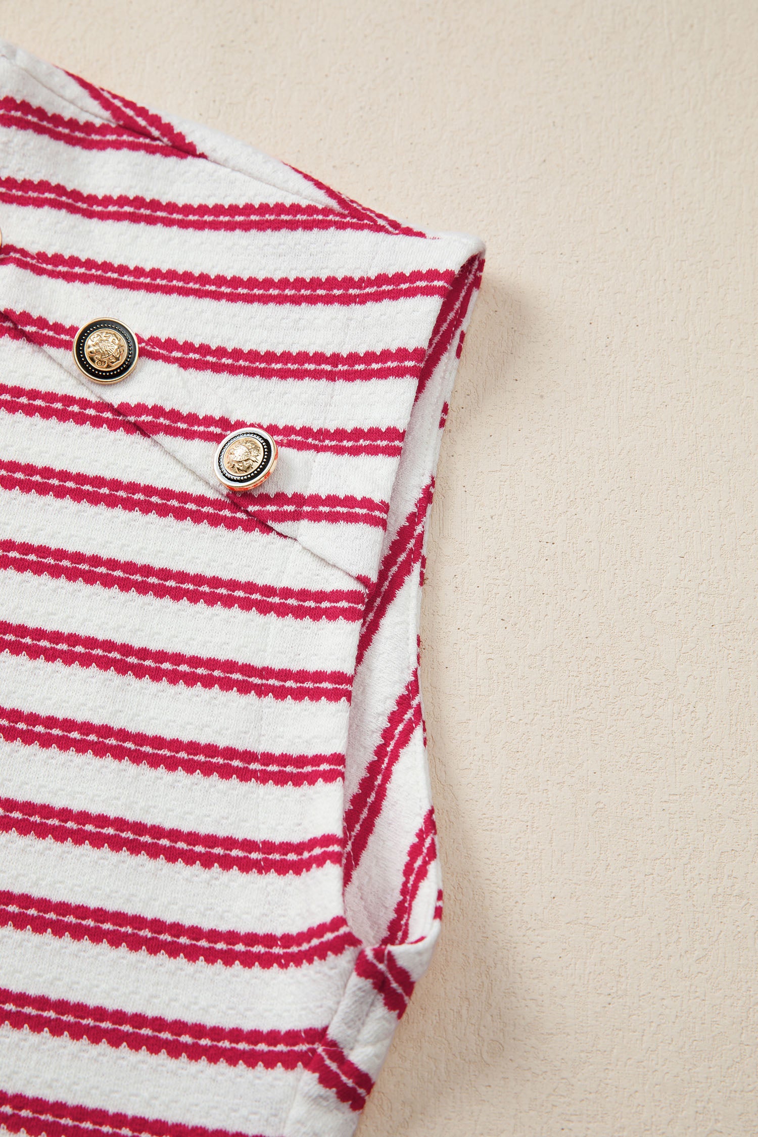 Textured knit tee with red stripes and decorative gold buttons