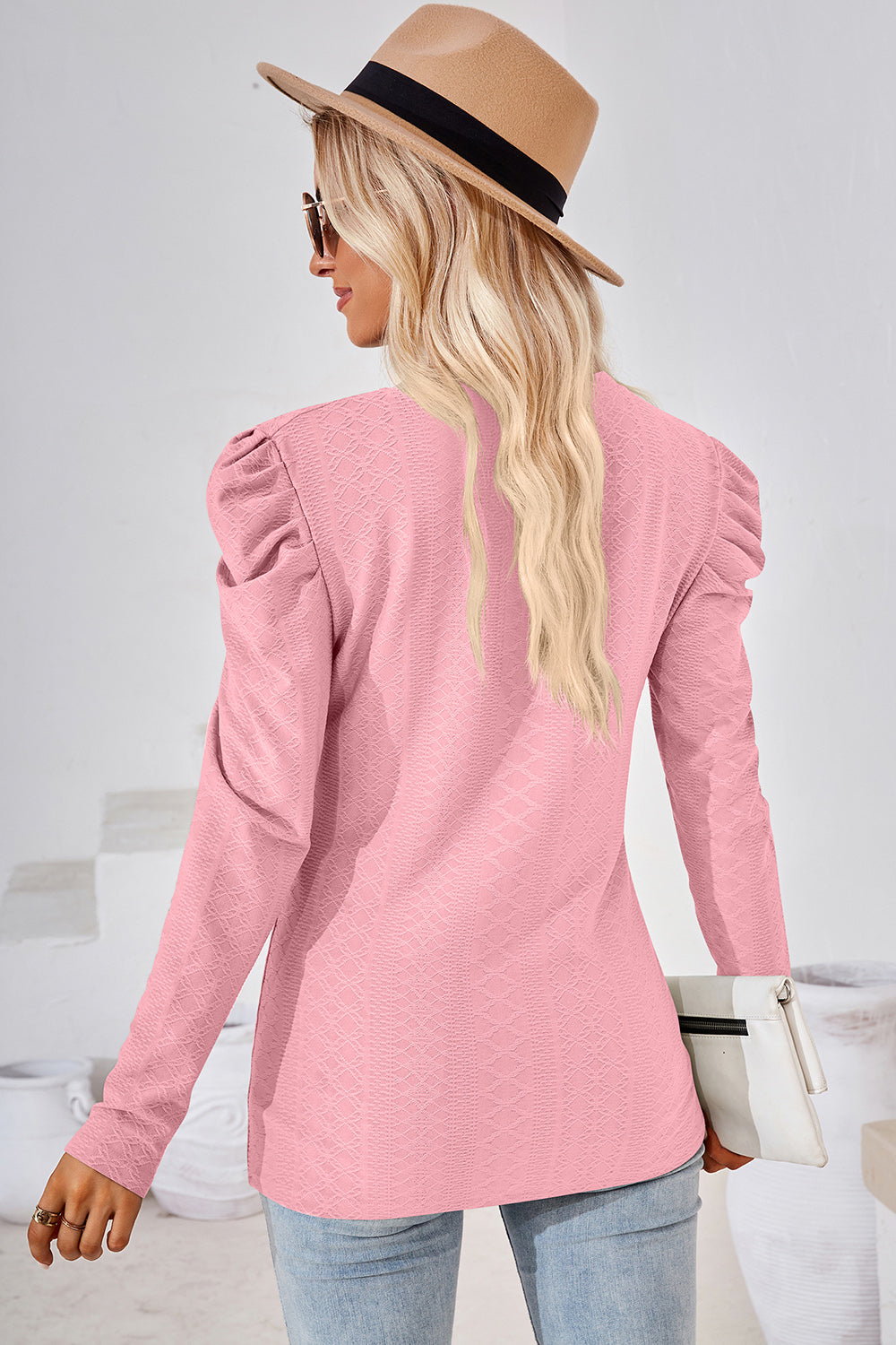 Blush pink textured puff-sleeve crew neck top with a subtle diamond pattern.