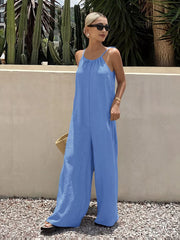 Blue tie-strap wide-leg romper with gathered neckline and flowy silhouette.