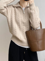 Beige cable knit quarter-zip pullover sweater with a collared neckline.