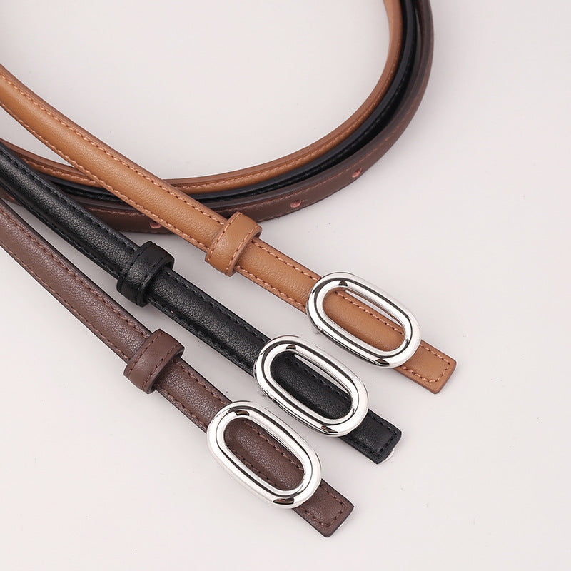 Sleek cowhide leather belts in coffee brown, black, and brown with oval silver buckles.