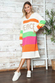 Beige knit midi sweater dress with rainbow stripes and "PEACE" lettering.