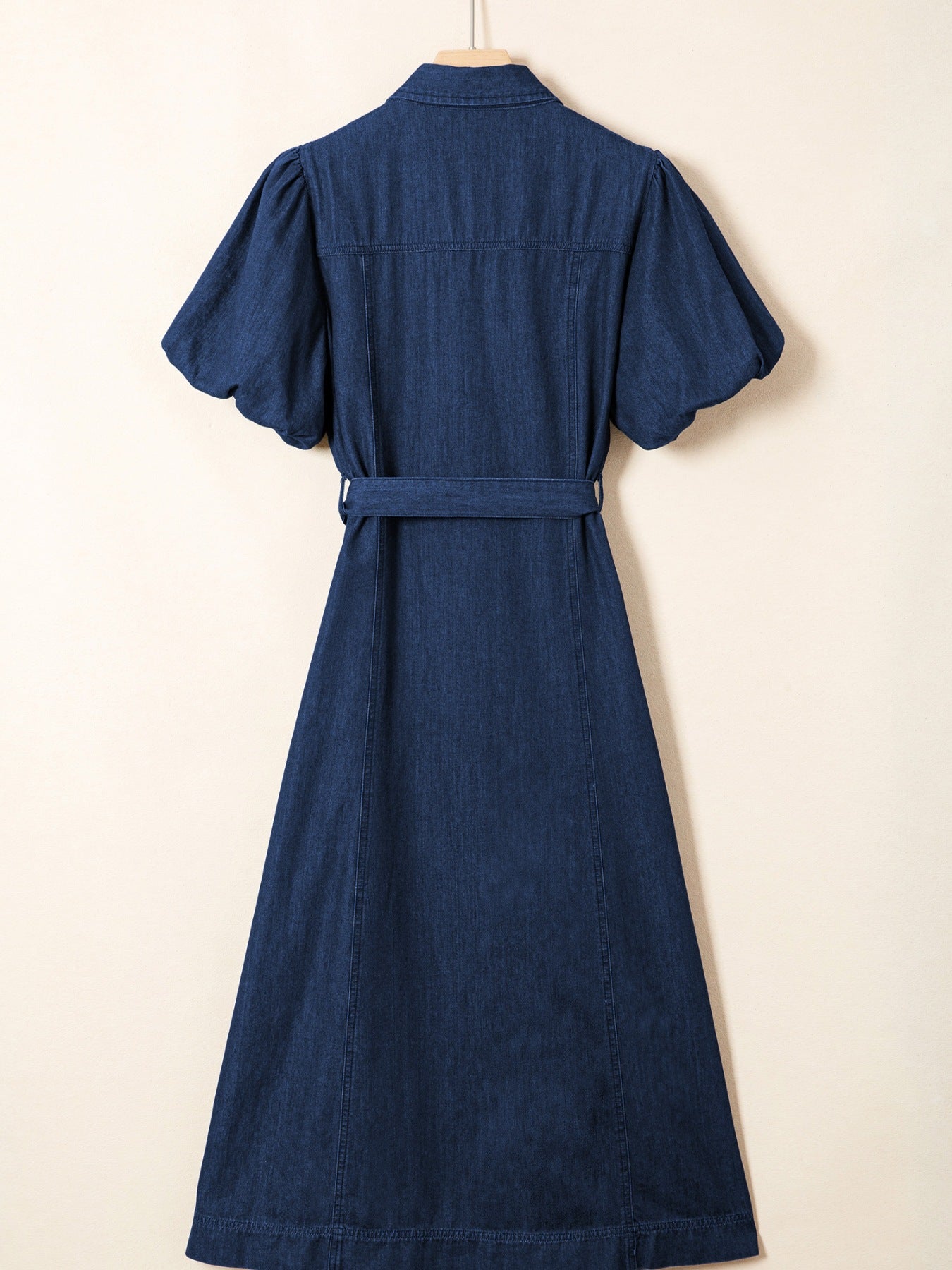 Denim midi dress with puff sleeves, belt, and button-down front.