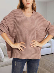 Dusty Pink ribbed knit batwing sweater with V-neck, relaxed fit, and acrylic blend.