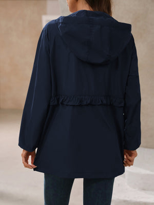 Navy hooded windbreaker jacket with ruffled waistline detail.