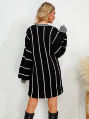 Black acrylic sweater dress with white vertical stripes and balloon sleeves.