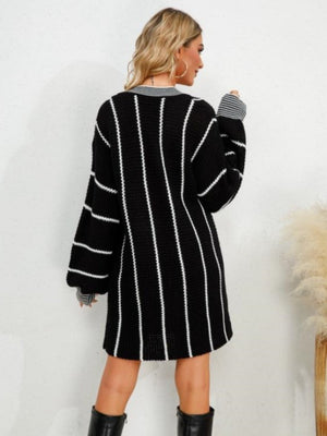 Black acrylic sweater dress with white vertical stripes and balloon sleeves.