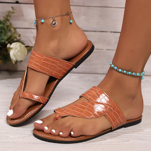 Brown crocodile-embossed luxe sandals with thong strap detail.