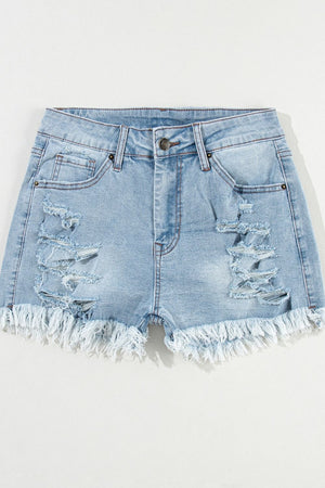 Light blue distressed denim cutoff shorts with frayed hem