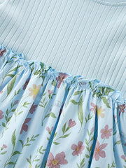 Baby dress with light blue ribbed knit top and floral print skirt with ruffles.