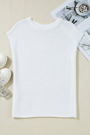 White boxy knit crop top with short sleeves and crew neck, acrylic fabric.