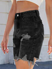 Black distressed denim bermuda shorts with frayed hem and ripped details.
