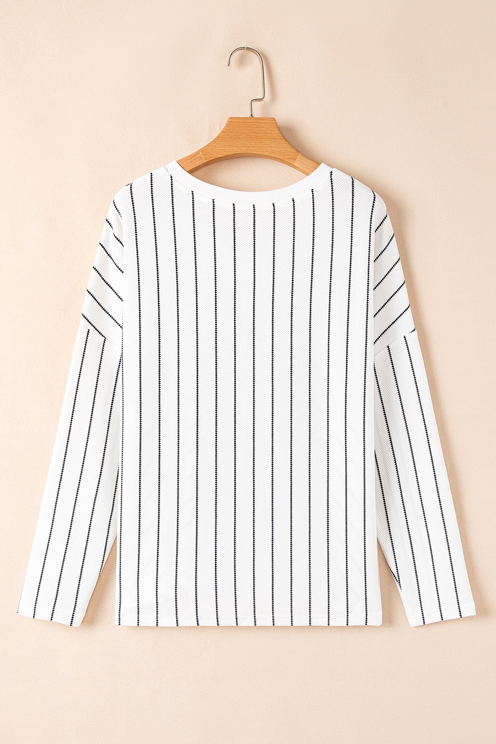 White long sleeve blouse with black vertical stripes and a crew neck.