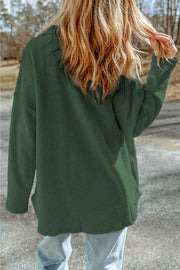 Dark green textured shacket with raw-edge detailing and pockets.