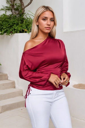Deep Red satin blouse with asymmetric neckline, ruched detail, and tie-side closure.