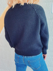Black cable knit raglan cardigan with ribbed cuffs and hem.