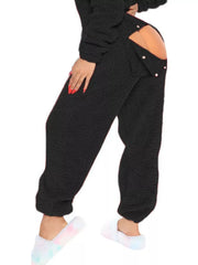 Black fleece hooded romper with open back and button detail.