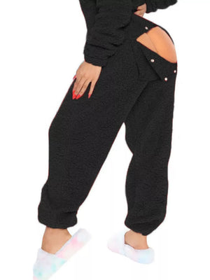 Black fleece hooded romper with open back and button detail.