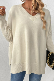 Cream v-neck knit sweater with ribbed sleeves and asymmetric hemline