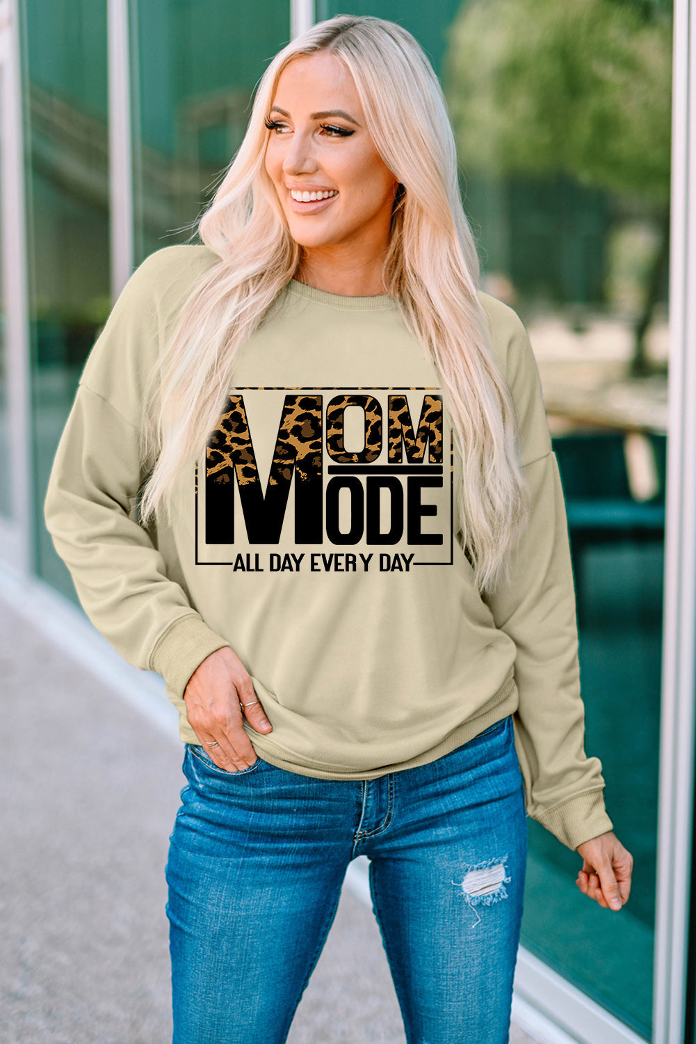 Khaki sweatshirt with leopard print "MOM MODE" graphic and long sleeves.