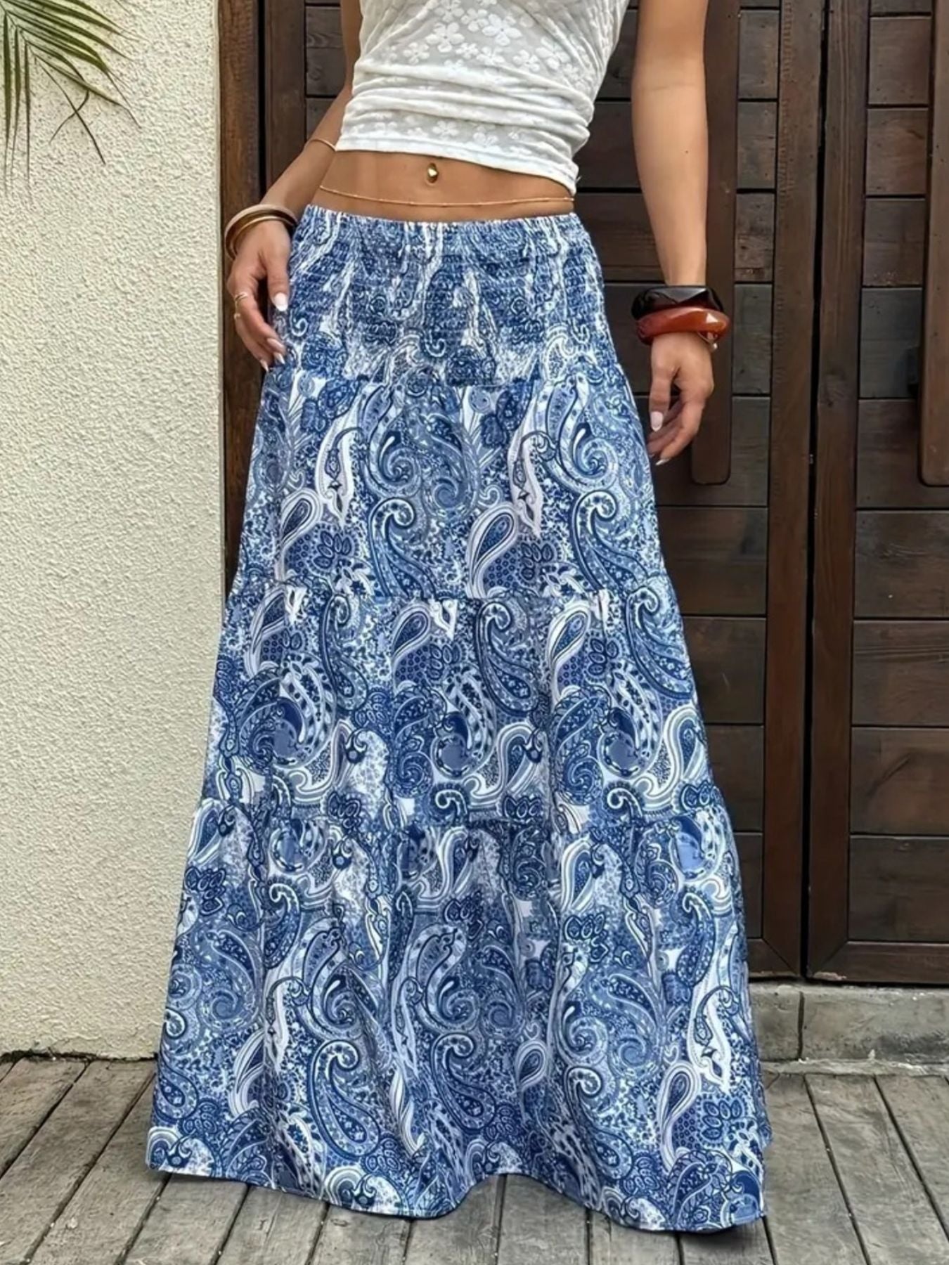 Bohemian paisley maxi skirt in blue with tiered ruffles and an elastic waistband.