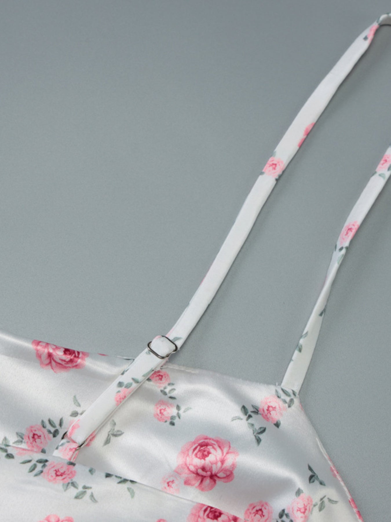 White floral print midi dress with adjustable spaghetti straps and a satin finish.