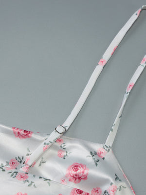 White floral print midi dress with adjustable spaghetti straps and a satin finish.