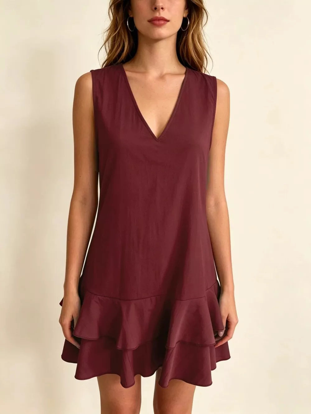 Burgundy tiered ruffle mini dress with V-neck and sleeveless design.