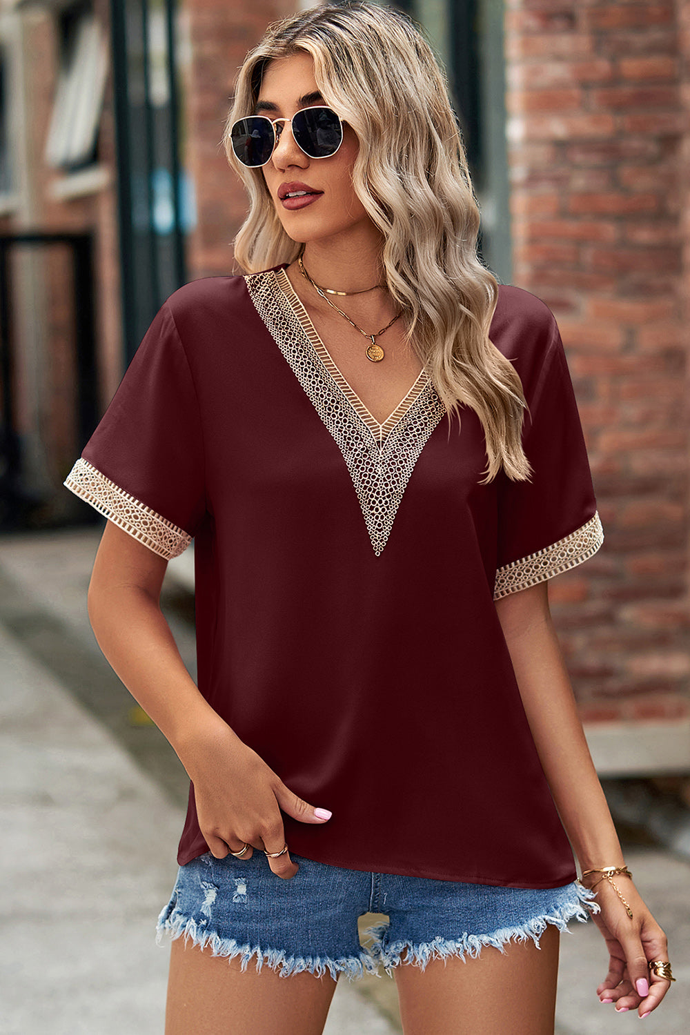 Burgundy V-neck blouse with lace trim on neckline and sleeves