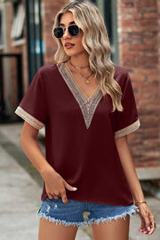 Burgundy V-neck blouse with lace trim on neckline and sleeves