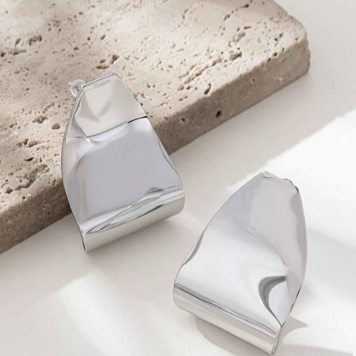 Silver alloy geometric earrings with a bold, abstract design.