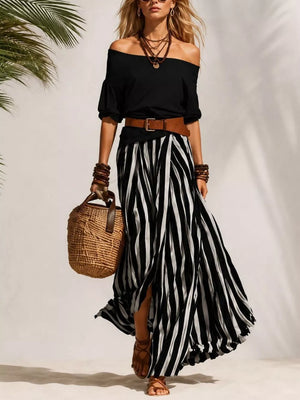 Black off-shoulder top with a striped maxi skirt and brown belt.