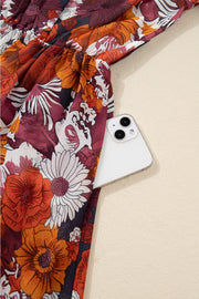 Floral wrap mini dress with puff sleeves and a cinched waist, featuring a bold floral print.