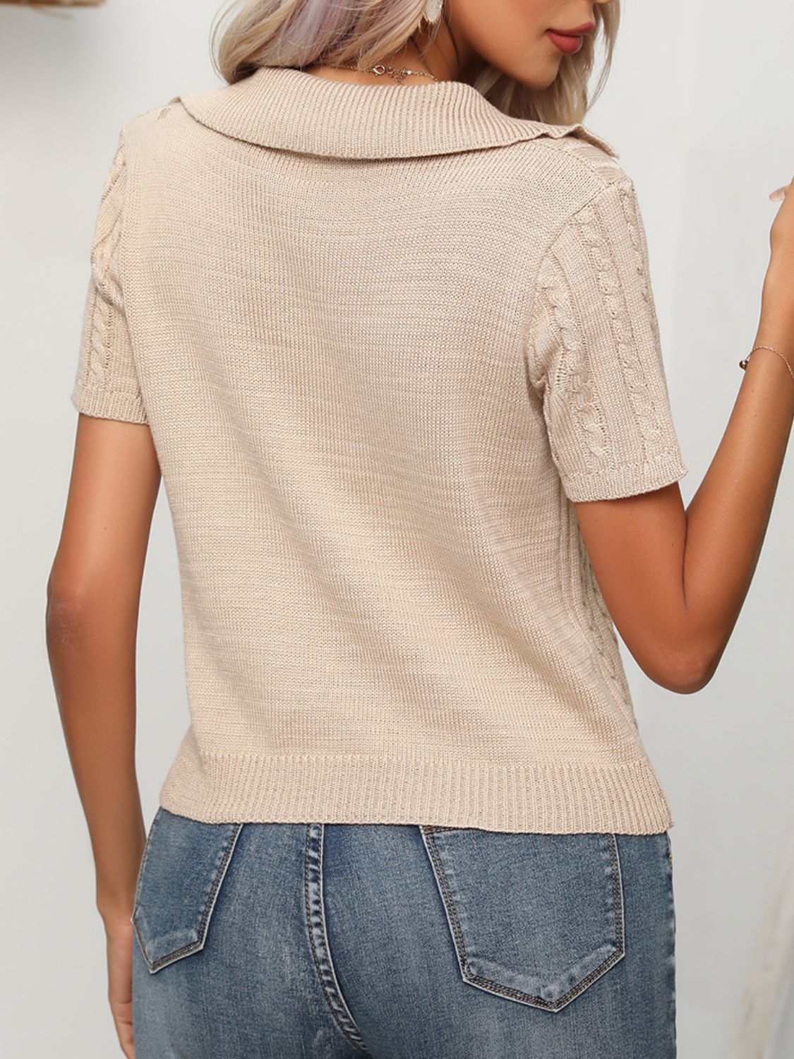 Tan knit polo sweater with short sleeves and cable knit detail on sleeves.