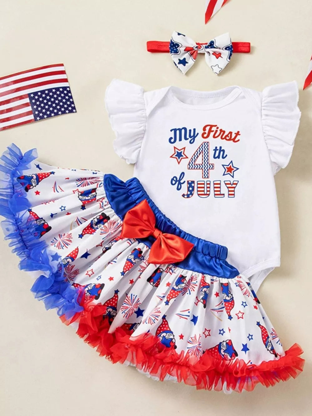 Baby girl 4th of July outfit set with ruffled sleeves, gnome print skirt, and matching headband.