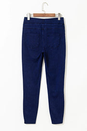 Dark wash denim jeggings with faux pockets and a slim fit.