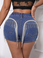 Medium wash denim shorts with crystal fringe detail on back pockets.