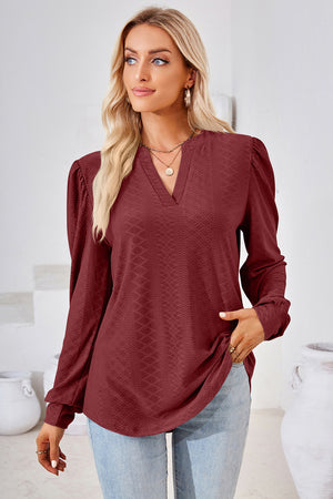 Textured puff sleeve henley blouse in rust with a v-neck and diamond pattern