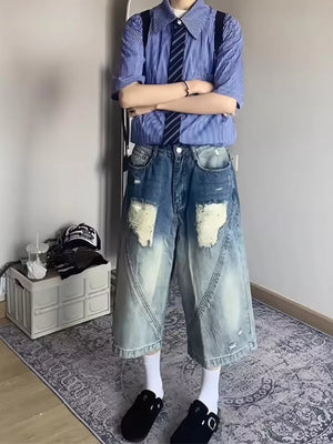 Relaxed fit distressed denim shorts in light wash with large distressed patches and raw hem.