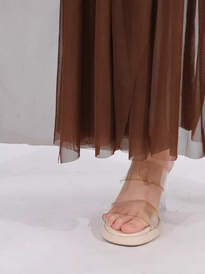 Brown draped one-shoulder maxi dress with sheer fabric detail.